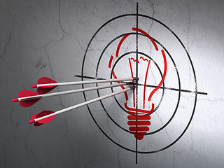 Image showing Finance concept: arrows in Light Bulb target on wall background