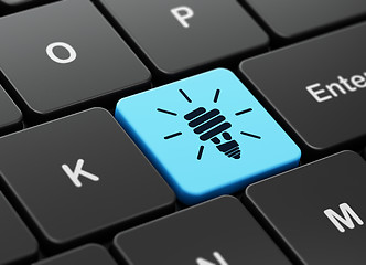 Image showing Finance concept: Energy Saving Lamp on keyboard background