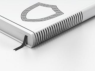 Image showing Safety concept: closed book, Contoured Shield on white