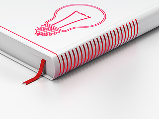 Image showing Finance concept: closed book, Light Bulb on white background