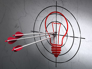 Image showing Business concept: arrows in Light Bulb target on wall background