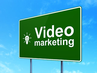 Image showing Finance concept: Video Marketing and Light Bulb on road sign background