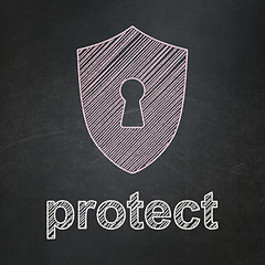 Image showing Protection concept: Shield With Keyhole and Protect chalkboard