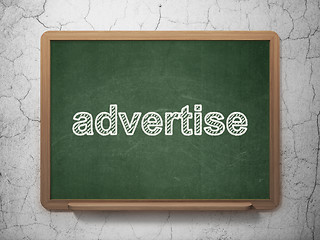 Image showing Advertising concept: Advertise on chalkboard background