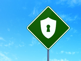 Image showing Privacy concept: Shield With Keyhole on road sign background