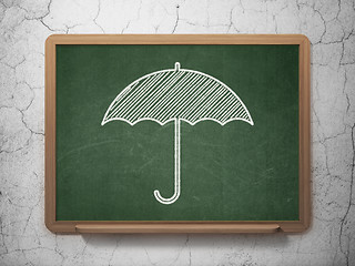 Image showing Security concept: Umbrella on chalkboard background