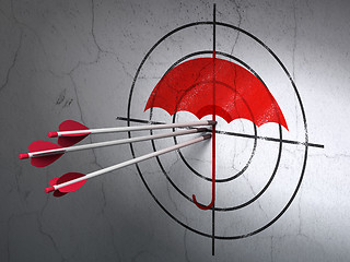 Image showing Protection concept: arrows in Umbrella target on wall background