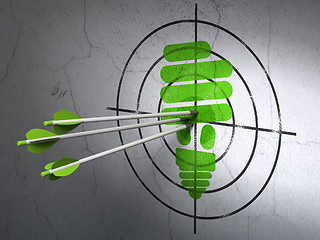 Image showing Business concept: arrows in Energy Saving Lamp target on wall