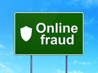 Image showing Safety concept: Online Fraud and Shield on road sign background