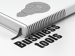 Image showing Business concept: book Light Bulb, Business Tools on white