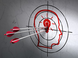 Image showing Business concept: arrows in Head With Lightbulb target on wall