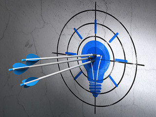 Image showing Business concept: arrows in Light Bulb target on wall background