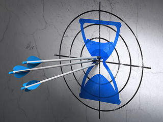 Image showing Timeline concept: arrows in Hourglass target on wall background