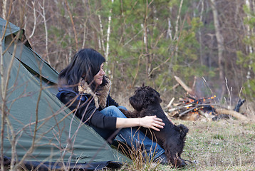 Image showing Woman with a dog camping