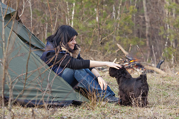 Image showing Woman with a dog camping