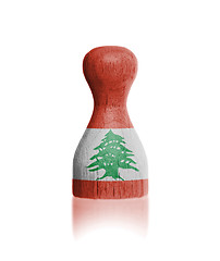 Image showing Wooden pawn with a flag painting