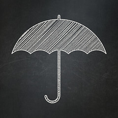 Image showing Security concept: Umbrella on chalkboard background