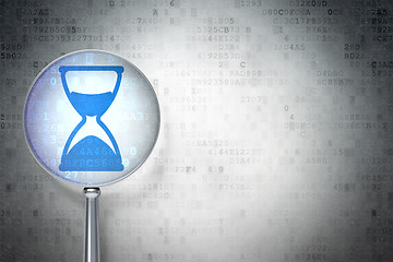 Image showing Time concept:  Hourglass optical glass on digital background