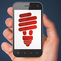 Image showing Finance concept: Energy Saving Lamp on smartphone