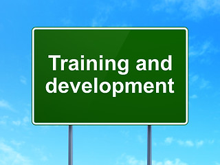 Image showing Education concept: Training and Development on road sign background