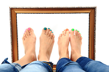 Image showing women feet and old frame 