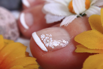 Image showing pedicure nails, feet and flowers