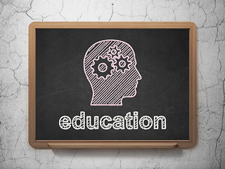 Image showing Head Gears and Education on chalkboard