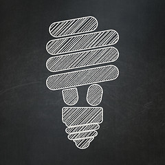 Image showing Finance concept: Energy Saving Lamp on chalkboard background