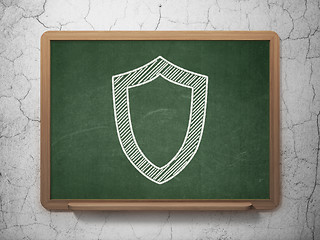 Image showing Protection concept: Contoured Shield on chalkboard background