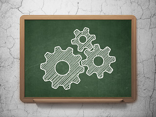 Image showing Advertising concept: Gears on chalkboard background