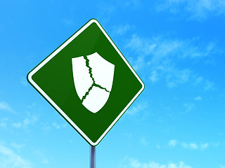 Image showing Protection concept: Broken Shield on road sign background