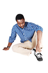 Image showing Black man sitting on floor.