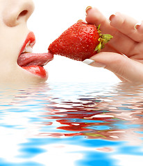 Image showing strawberry, lips and tongue in water