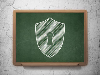 Image showing Protection concept: Shield With Keyhole on chalkboard background