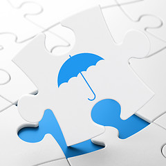 Image showing Safety concept: Umbrella on puzzle background