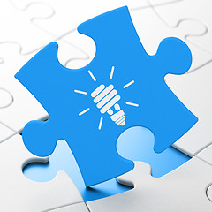 Image showing Business concept: Energy Saving Lamp on puzzle background