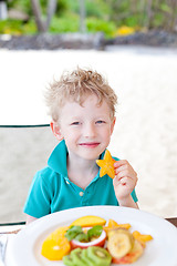 Image showing kid eating fruits