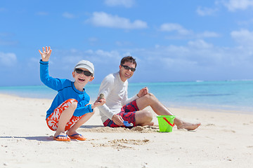 Image showing family building sand castle