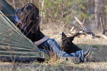 Image showing Woman with a dog camping