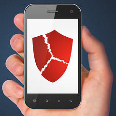 Image showing Security concept: Broken Shield on smartphone