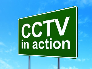 Image showing Safety concept: CCTV In action on road sign background