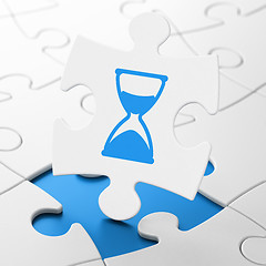 Image showing Time concept: Hourglass on puzzle background