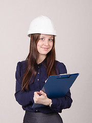 Image showing Young woman in helmet records customer's needs