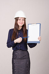 Image showing Beautiful girl shows a pencil inscription on folder