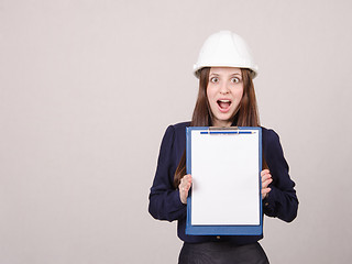 Image showing Girl shocked by inscription on sheet in folder