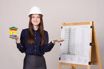 Image showing Girl advertises multi-storey building under construction