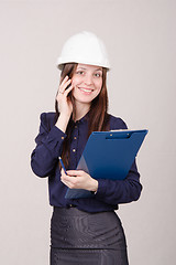 Image showing Beautiful girl talking on phone with a client