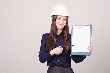 Image showing Girl helmet indicates inscription in pencil on a folder