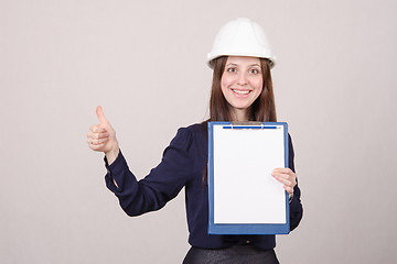 Image showing Girl a helmet standing with folder in hand