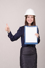 Image showing Girl in helmet standing with a folder hand